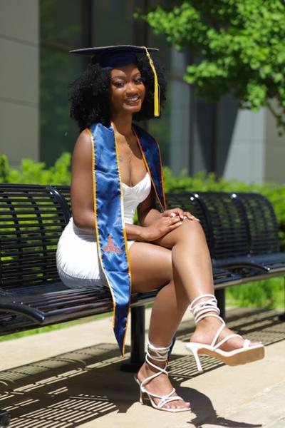 Female College Student in White Wearing a Mortarboard